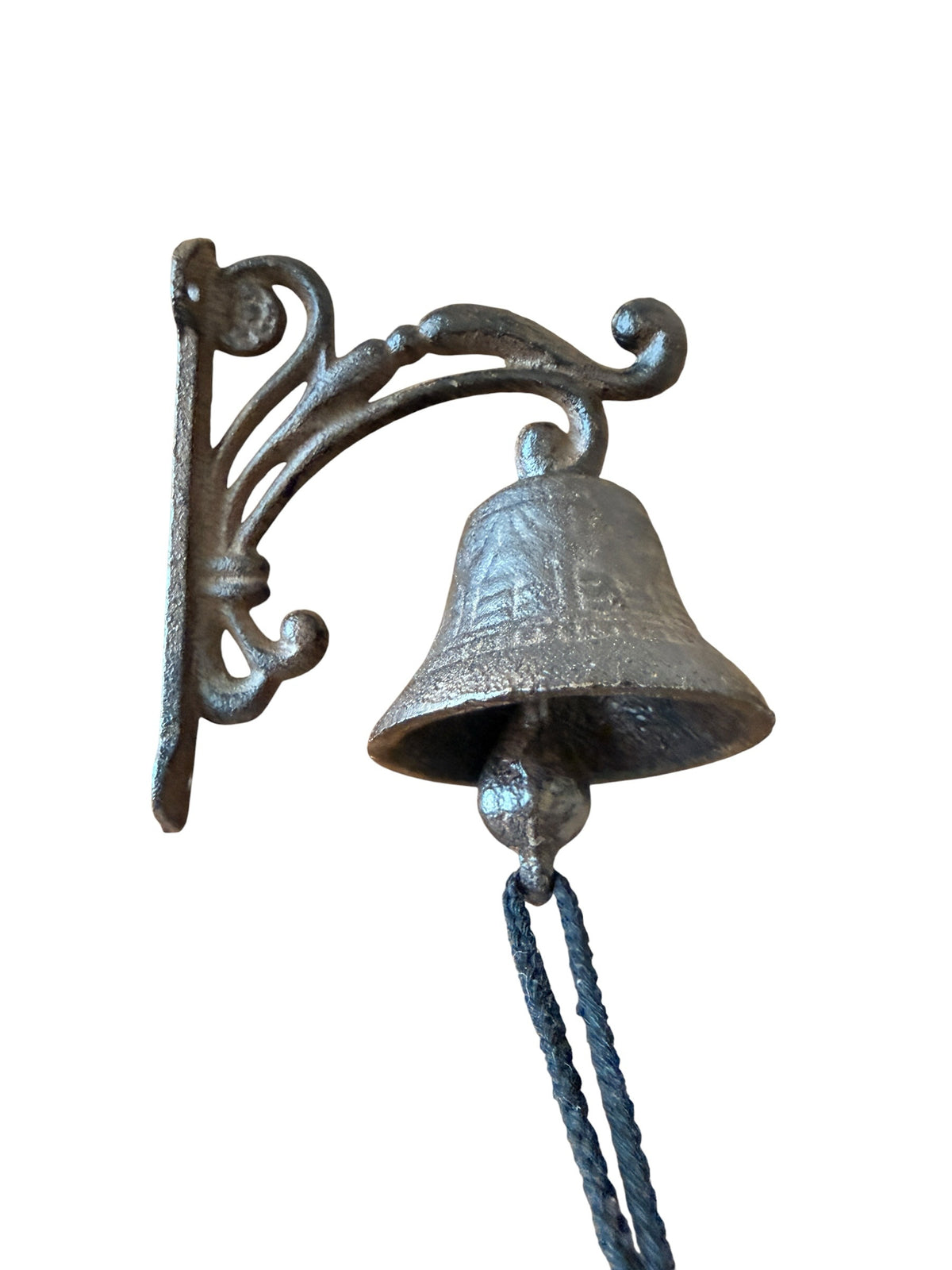 Chica Mexico cast iron wall-mounted bell with an ornate scrolled bracket and rope pull for a rustic farmhouse look.